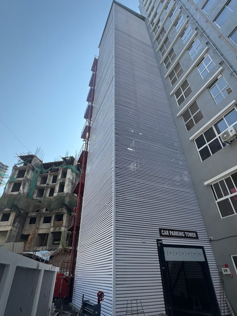 Front view of the Car Parking Tower entrance with white horizontal Upvc Fin cladding, Sainath Residency, Bhandup