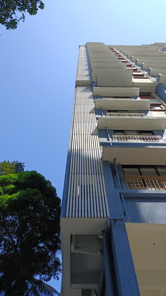 White square Upvc Fins running the full height of the duct corner at Bhaveshawar Heights, Dahisar