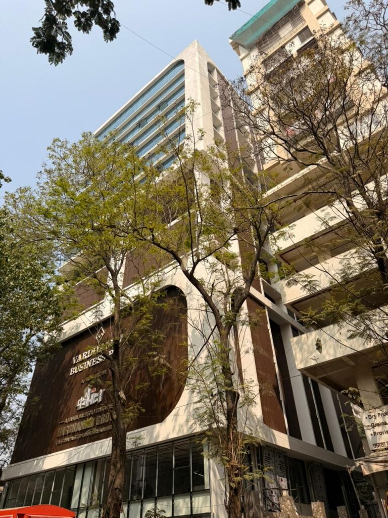 Vertical dark brown Upvc fin bands running the full height of the Vardhaman Business Bay tower, Ghatkopar